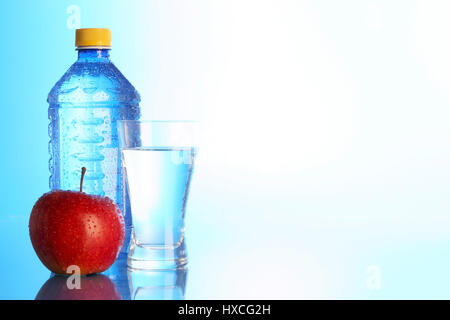 Glass with mineral water, bottle and apple, Glas mit Mineralwasser, Flasche und Apfel Stock Photo