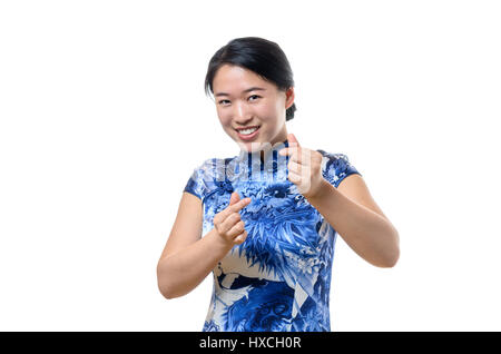 Beautiful Chinese woman in traditional dress gesturing a love sign with fingers Stock Photo