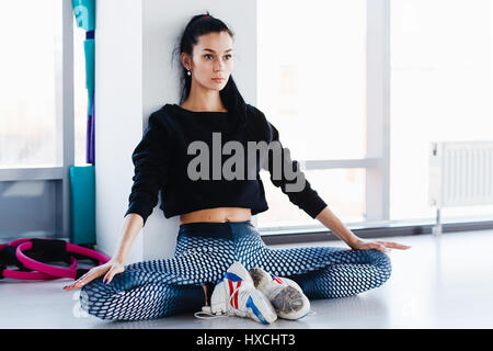 Young women doing stretching exercises on yhe bars in the aerobics class on the foreground Stock Photo