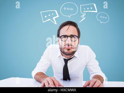 Digital composite of Man at desk with white speech bubbles against blue background Stock Photo