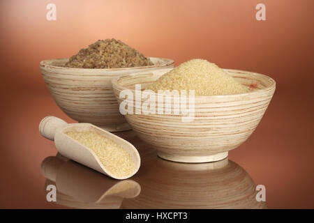 Wooden bowls with pipe sugar, Holzschalen mit Rohrzucker Stock Photo