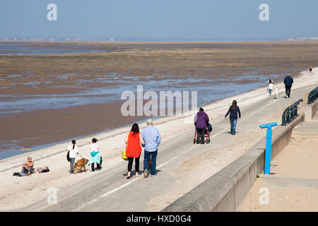 Southport, Merseyside, UK. Uk Weather. 27th March, 2017. Blistering sunshine on beach & pier for strollers enjoying a brilliant spring day in the resort. Credit: MediaWorldImages/AlamyLiveNews Stock Photo