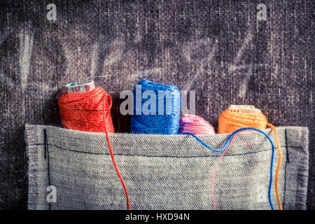 Colored threads in the pocket of the mat tailor Stock Photo