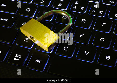 Closed lock and SSL key on a backlit computer keyboard Stock Photo