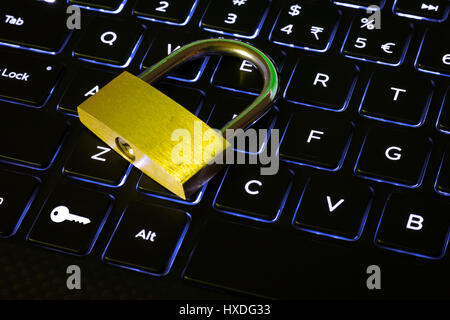 Closed lock and key button on a backlit computer keyboard Stock Photo