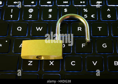 Open security lock on a backlit computer keyboard Stock Photo