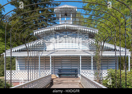 Romantic scaffold spanned by a graceful arcade overlooking a folly in the loo park located in Apeldoorn in the Netherlands Stock Photo