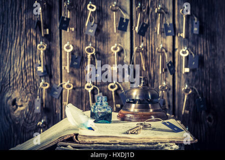 Vintage front desk in hotel with keys for rooms and guestbook Stock Photo