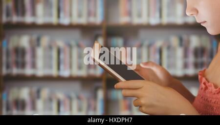 Digital composite of girl on tablet in Library Stock Photo
