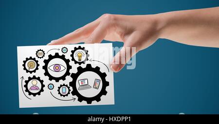Digital composite of Hand with card and gear graphics against blue background Stock Photo