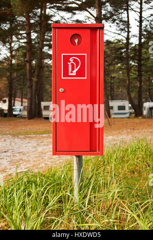 Fire extinguisher on a camping place on the Baltic Sea, Fire extinguisher At a camp site on the Baltic Sea |, Feuerlöscher auf einem Campingplatz an d Stock Photo
