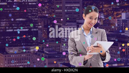 Digital composite of Woman with tablet against Night city with connectors Stock Photo