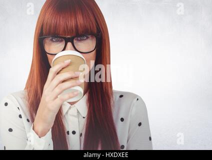 Digital composite of Close up of woman with coffee cup over face against white wall Stock Photo