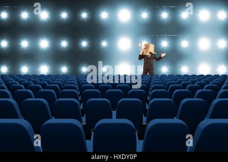 Digital composite of model with box on his had with megaphone at 3d cinema Stock Photo
