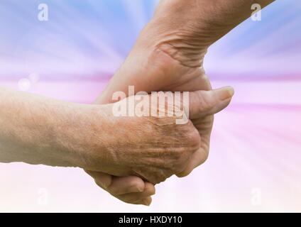 Digital composite of Hands holding eachother kindness against abstract background Stock Photo