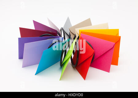 Different colored envelopes on the white table. Stock Photo