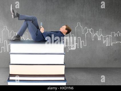 Digital composite of Businessman lying on Books stacked by city drawing with tablet Stock Photo