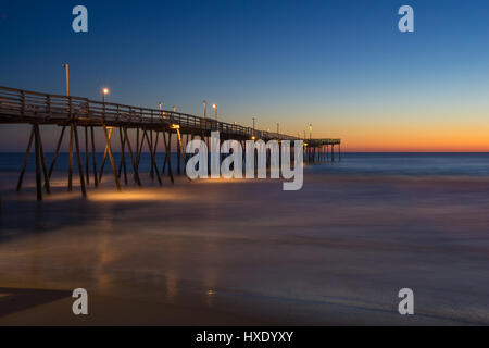 Sunrise long exposure of fishing pier along the beach of the Outer Banks of North Carolina Stock Photo