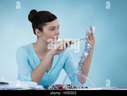 Digital composite of Woman with electronics against blue background Stock Photo