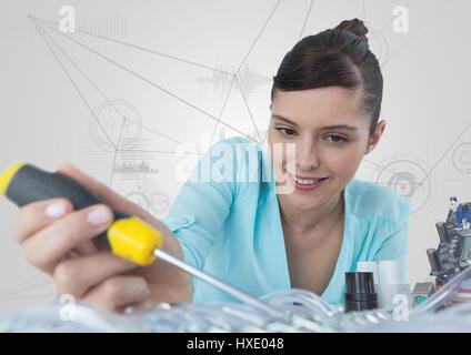Digital composite of Woman with electronics and screwdriver against white background with graphs Stock Photo