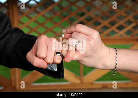 wedding rings hands of bride and groom Stock Photo