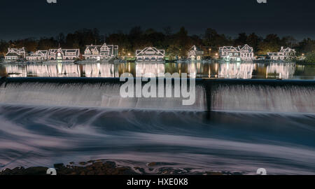 Illuminated houses along boathouse row reflect on the Schuylkill River. Stock Photo