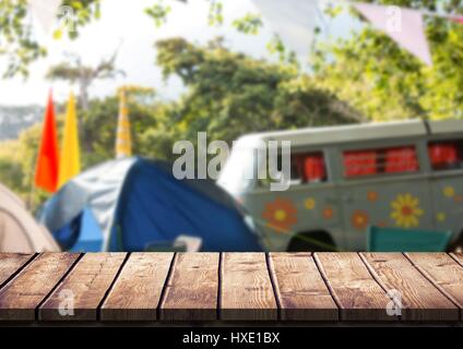 Digital composite of Wood table against blurry campsite Stock Photo