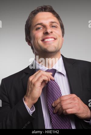 Digital composite of Close up of business man against grey background Stock Photo