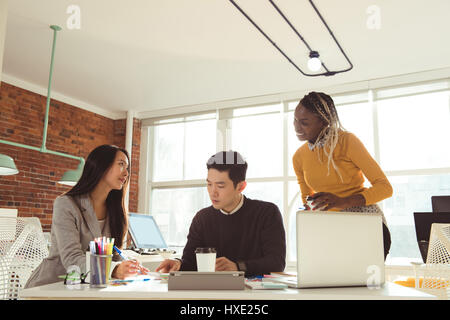 Group of executives working together at desk in office Stock Photo