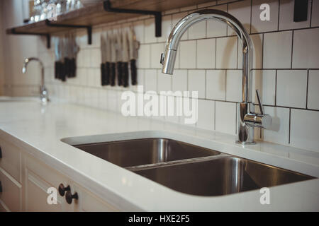 Close-up of chrome sink and faucet in professional kitchen Stock Photo