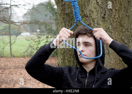 Depressed teenage boy with a hangman's noose Stock Photo