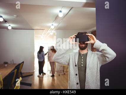 Male executive using virtual reality headset in office Stock Photo