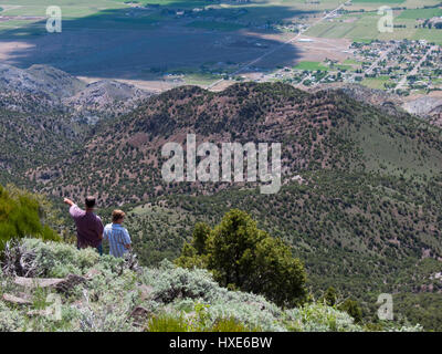 A father and son look at the view from the side of a mountain in Monroe, Utah, USA. Stock Photo