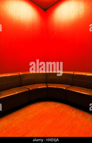 Modern waiting room interior with empty leather seats and hardwood flooring Stock Photo