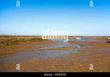 A view of an inlet at low tide in an Area of Outstanding Natural Beauty in North Norfolk at Brancaster Staithe, Norfolk, England, United Kingdom. Stock Photo