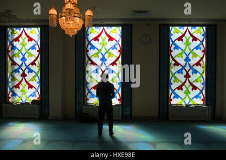 A man prays at the hall of the Moscow Cathedral Mosque, Russia Stock Photo