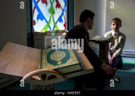 A boy is studying the Koran at the hall of Moscow Cathedral Mosque, Russia Stock Photo