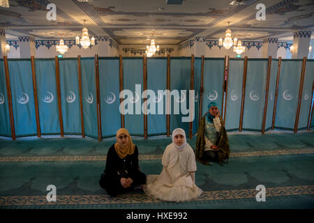 Asian girls praying in the Cathedral mosque in Moscow, Russia Stock Photo