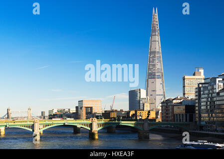 A view of the River Thames featuring The Shard (310m) with Southwark Bridge in the foreground on a bright spring afternoon, London, UK Stock Photo