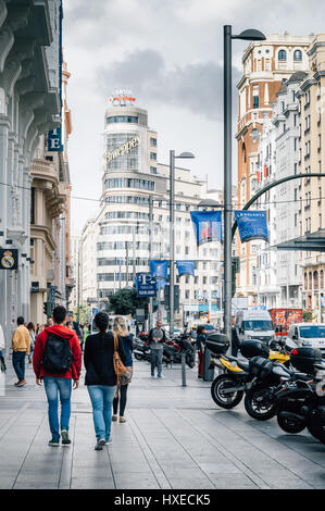 Madrid, Spain - September 14, 2016: People walking in Gran Via in Madrid. It is an ornate and upscale shopping street located in central Madrid. It is Stock Photo