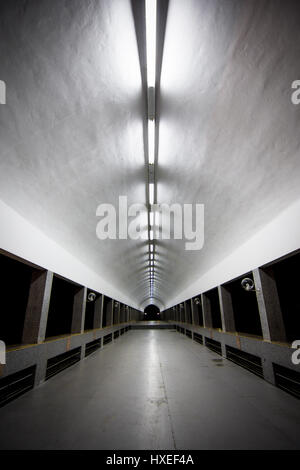 A long covered illuminated walk way tunnel leading away from Brunei's largest mosque. The Jame Asr Hassanil Bolkiah Mosque. Stock Photo