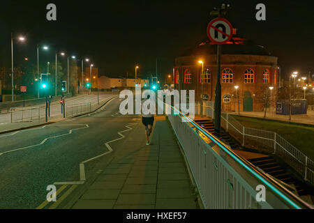 runner on Glasgow street  night crossing bridge no u turn green lights on traffic lights go Stock Photo