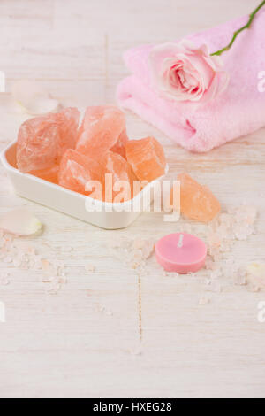 Spa settings with roses. Various items used in spa treatments on white wooden background. Stock Photo
