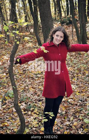 Smiling young woman in forest Stock Photo