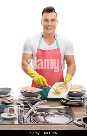 Cheerful young man doing the dishes isolated on white background Stock Photo