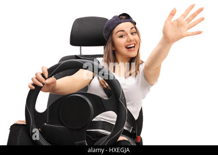 Joyful teen driver waving at the camera isolated on white background Stock Photo