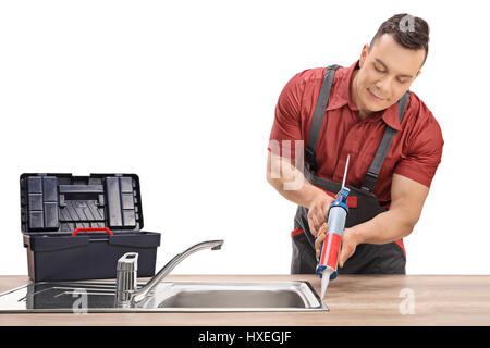 Plumber using a silicone tube on a sink isolated on white background Stock Photo