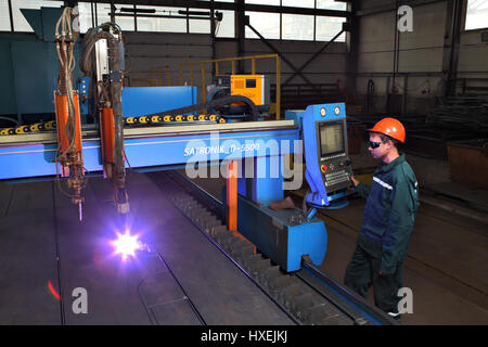 Saint  Petersburg, Russia - October 10, 2014: The metal factory, a worker operates a system of thermal cutting of metal sheets, plasma cutting machine Stock Photo
