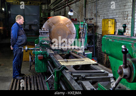 St. Petersburg, Russia - May 21, 2015: Metal processing on a large lathe, turner machine operator controls the process, turning shop at the plant of m Stock Photo