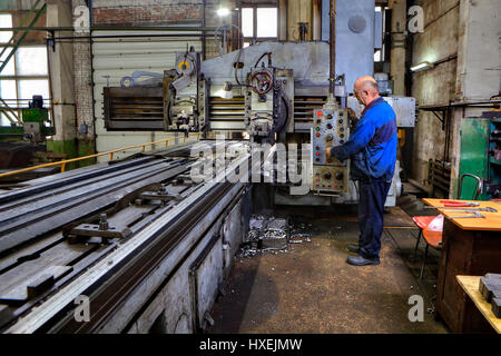 St. Petersburg, Russia - May 21, 2015: Planing and milling longitudinal machine tool, Machine tool operator planing and milling double column. Stock Photo